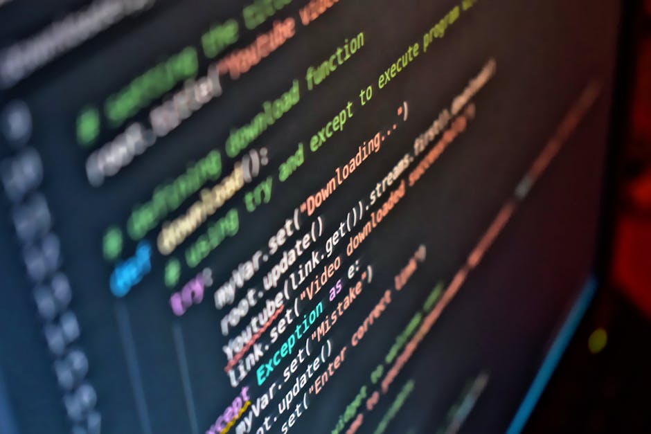 A close-up image of a computer screen displaying colorful programming code, with syntax highlighting in shades of green, pink, blue, and orange. The code appears to involve system or web development f